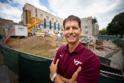 Chip Blankenship stands in front of the under-construction Holden Hall